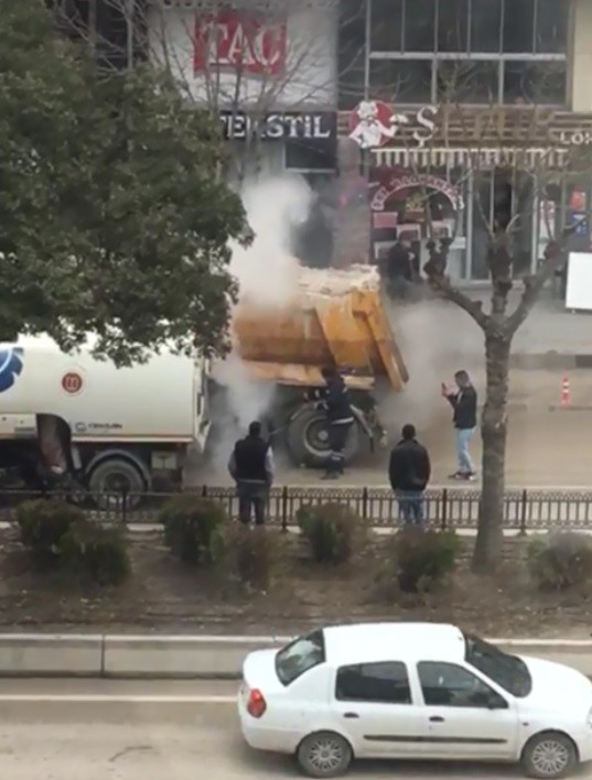 Bilecik’te aracının lastiği tutuşan sürücü alevleri söndürmek için büfeden su taşıdı